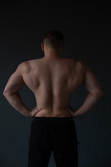 Obraz na płótnie Canvas athletic guy strains his back