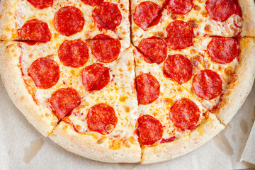 fresh pepperoni pizza on baking paper