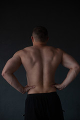 Fototapeta na wymiar athletic guy strains his back
