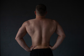 Fototapeta premium athletic guy strains his back