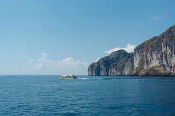Fototapeta na wymiar island in the sea with the boat and blue sky