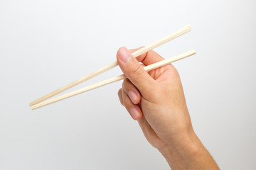 Disposable wooden chopsticks on white background