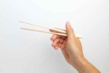 Disposable wooden chopsticks on white background