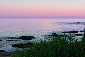 sunset on a beach with rocks