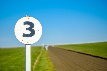 3 furlong distance marker seen on the edge of a professional flat-racing training track in the UK....