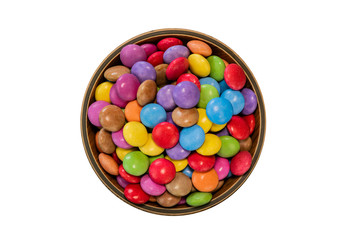 Colorful candies in a wooden bowl case isolated on wood background