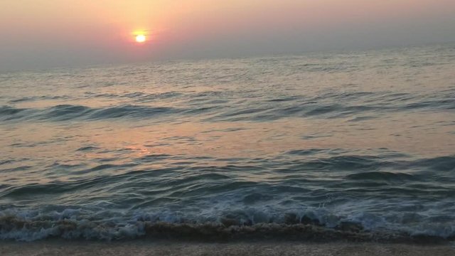 4K Sunrise over tropical island beach and palm trees. Phuket beach sea, View of beach sea on sun light in the summer. Colorful sunset over the beach in the tropical beach sea,the tropical paradise bea