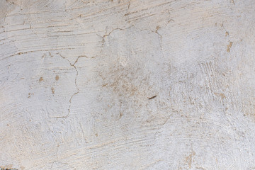 Background of old damaged adobe house with cracked plaster. Grungy texture of old weathered stucco wall. Retro aged surface. Antique and textured backdrop. Rough shabby structure, textured pattern