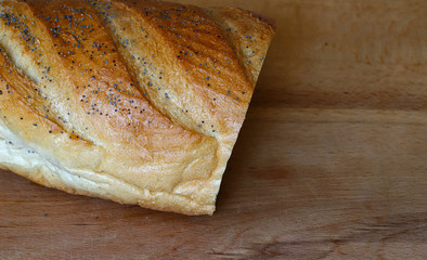 freshly baked bread on a wooden kitchen table, top view.