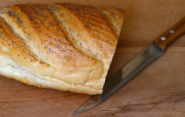 freshly baked bread on a wooden kitchen table, top view.
