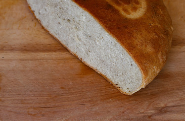 freshly baked bread on a wooden kitchen table, top view.