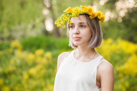 Spring Girl In Dandelion Flowers Crown Outdoors