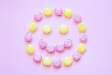 Multicolored candy on a colored background. Flat lay