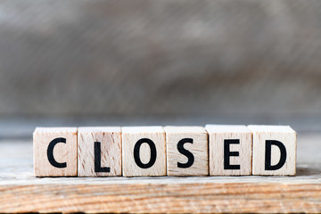 CLOSED. Word arranged from wooden letters Closed.