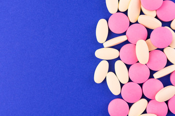 Pills on a blue background. The concept of medicine, pharmacy and healthcare. Copy spaces.