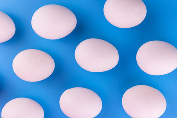 White eggs on a blue background. Background of eggs.