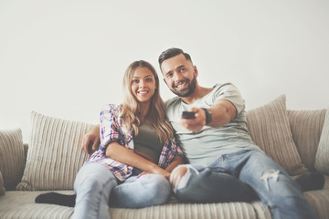 Young couple enjoying themselves on the sofa in the living room