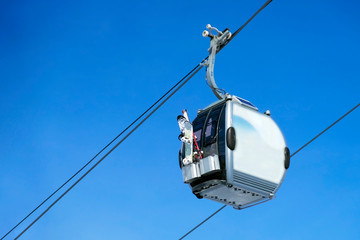 Cable car way on blue sky background. Gondola lift.