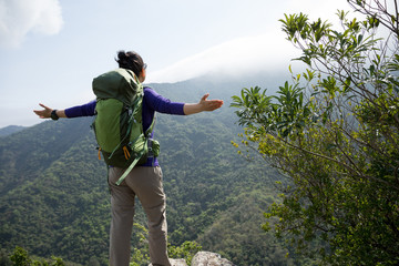 Successful hiker enjoy the view on mountain top