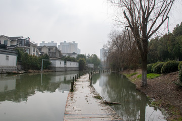 Fototapeta premium A sunken pier going out into a misty canal