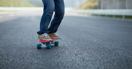 Skateboarder skateboarding on highway road