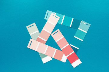 Selection of palette for painting, sample color catalog on a turquoise green background, different shades of pink and green colors