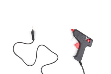 Electric hot glue gun on white background. Rods for glue gun