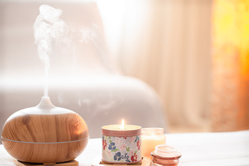 Modern oil aroma diffuser in the living room on the table .