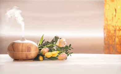 Aroma oil diffuser lamp on the table .