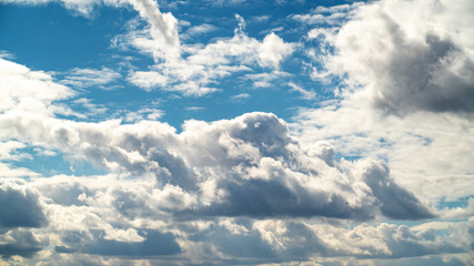 disturbing blue sky with white swirling clouds