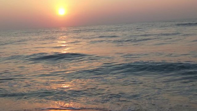 4K Sunrise over tropical island beach and palm trees. Phuket beach sea, View of beach sea on sun light in the summer. Colorful sunset over the beach in the tropical beach sea,the tropical paradise bea