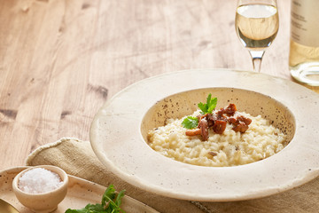 Risoto with chanterelle mushrooms in large plate. Traditional italian dish.