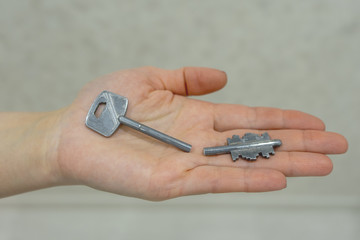 A broken door key on a woman's hand, the concept of lost property.