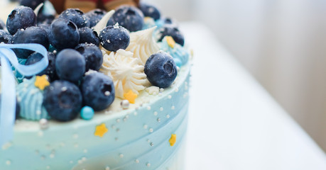 Cake in blue with blueberries and blue bow