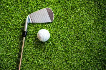 Playing golf on the green grass.