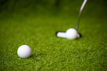 Playing golf on the green grass.