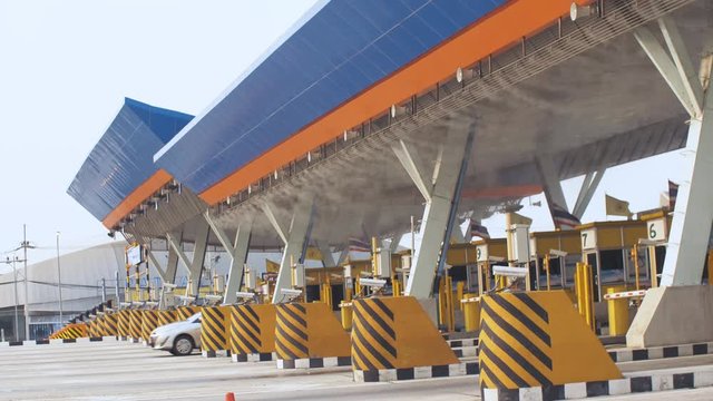 Antibacterial and antiviral treatment of toll roads in Thailand. Spraying chemical fluid over cars. Disinfection of vehicles, roads. Virus coronavirus epidemic pandemic sars-cov-2 covid-19 2019-ncov.