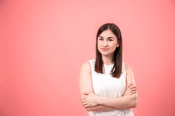 Portrait of a young woman on an isolated pink background.