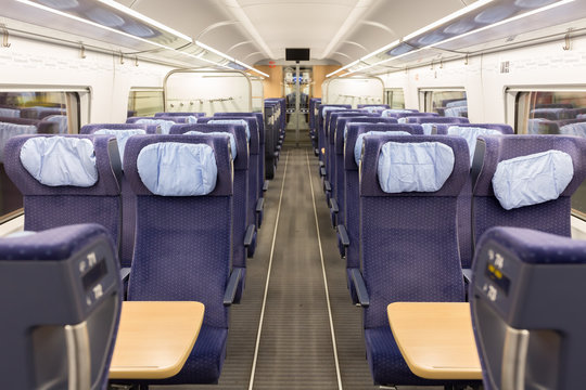 Munich, Bavaria / Germany - Mar 10, 2020: Interior of an empty ICE (Intercity Express) train. Straight view along the aisle / gangway with blue seats on both sides. No people.