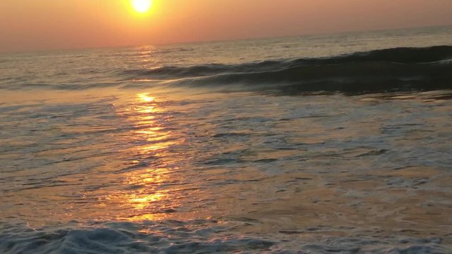 4K Sunrise over tropical island beach and palm trees. Phuket beach sea, View of beach sea on sun light in the summer. Colorful sunset over the beach in the tropical beach sea,the tropical paradise bea