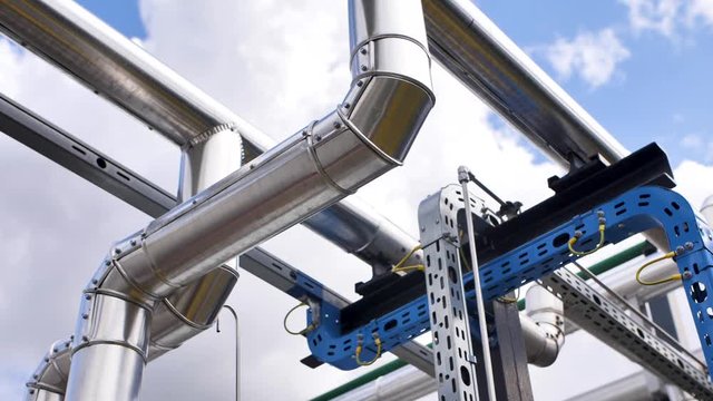 Steel pipes against the sky, reflection of light