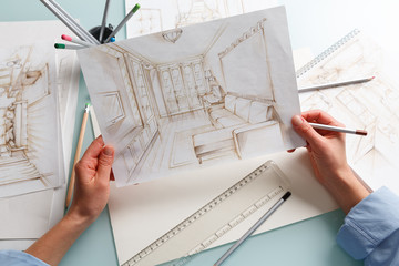 Interior designer drawing pencil scetch of a living room