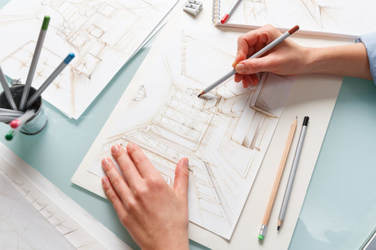 Interior designer drawing pencil scetch of a living room