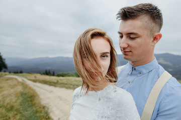 Fototapeta premium Photoshoot of the bride and groom in the mountains. Boho style wedding photo.