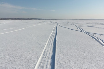 Trail from a snowmobile on a frozen river, Novosibirsk, Russia