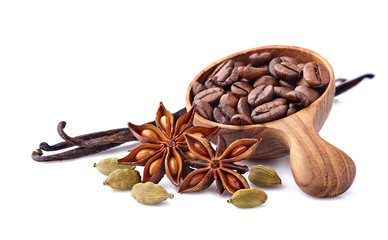 Coffee beans with cardamom, vanilla  and  anise in wooden spoon on white background. Spices isolated.
