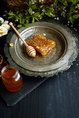 Honeycomb with delicious honey on black background 
