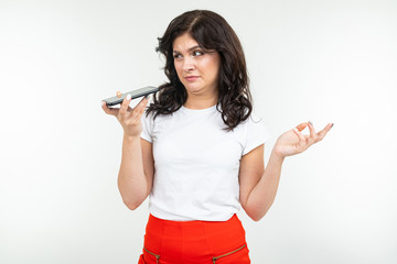 brunette woman talking on the phone handsfree on an isolated white background