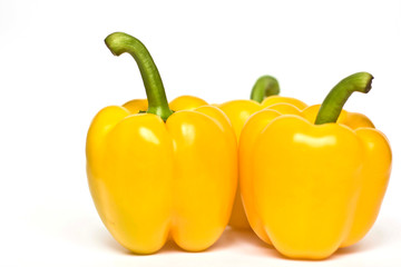 THREE YELLOW PEPPERS ISOLATED ON WHITE