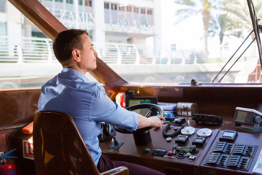 A man drives a sea pleasure boat.